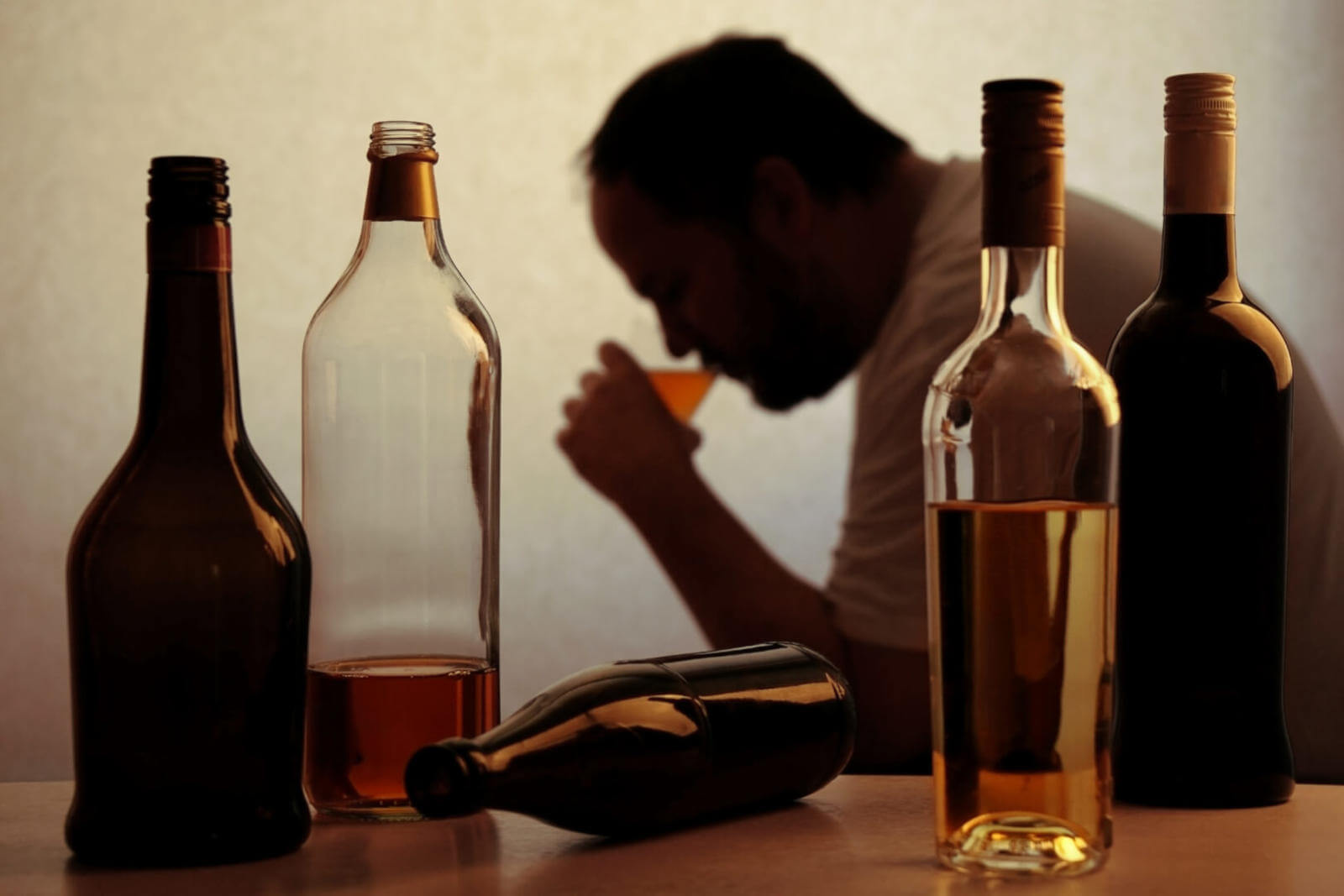 man with alcoholism drinking