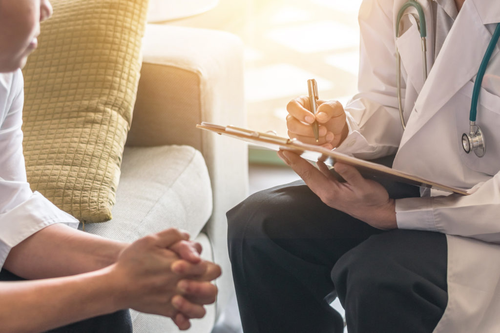 Woman patient having consultation with doctor (gynecologist or psychiatrist) and examining health in medical gynecological clinic or hospital mental health service center