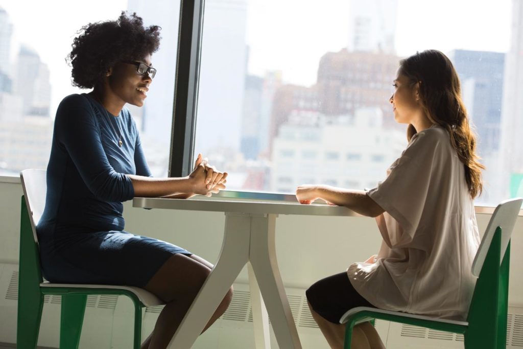 photo of a woman trying to talk to her boss about her substance abuse disorder