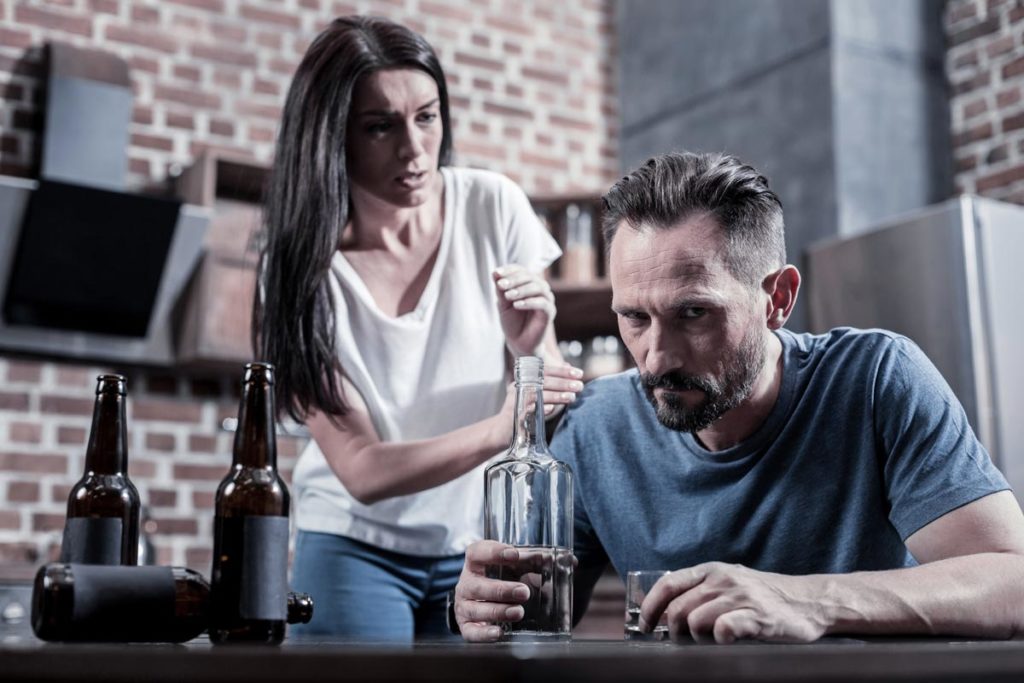 photo of an alcoholic husband and upset wife