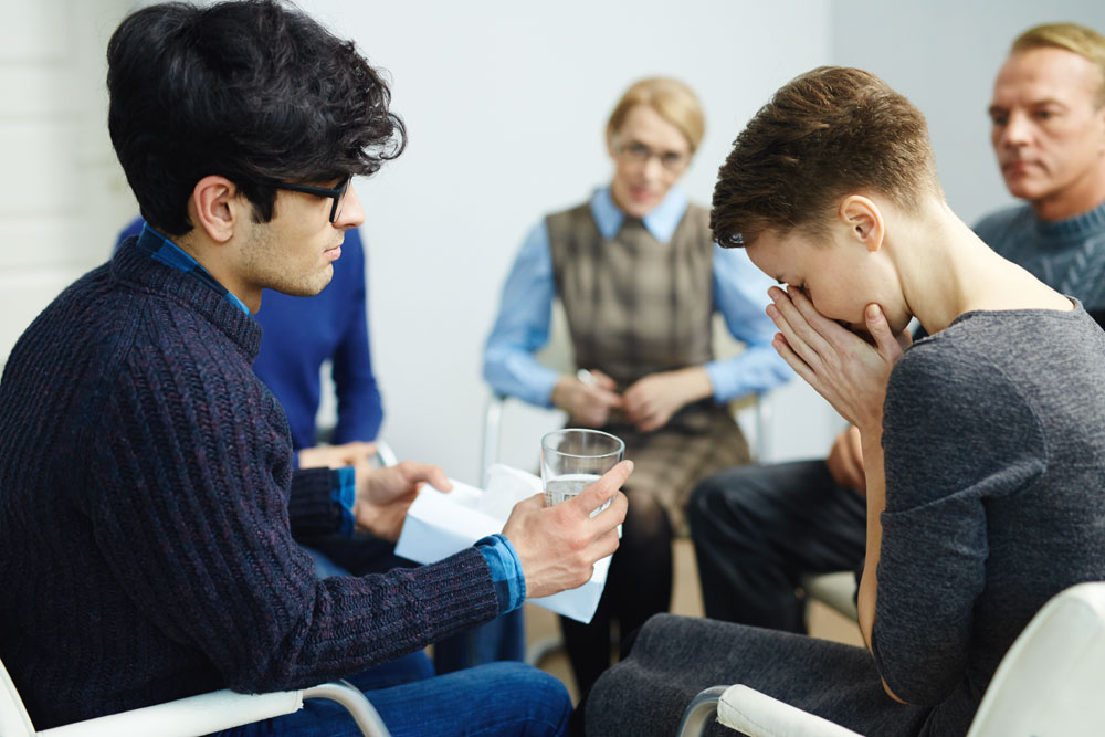photo of woman crying during a group therapy
