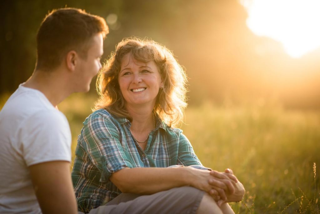 Photo of Mother with her adult son against nature background