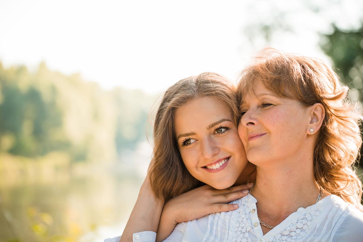Photo of Mother with her daughter against nature background