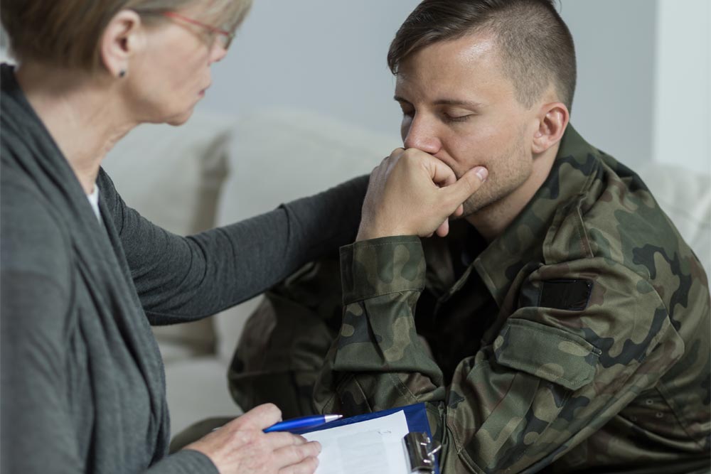 a soldier with PTSD attending a therapy with a Psychologist