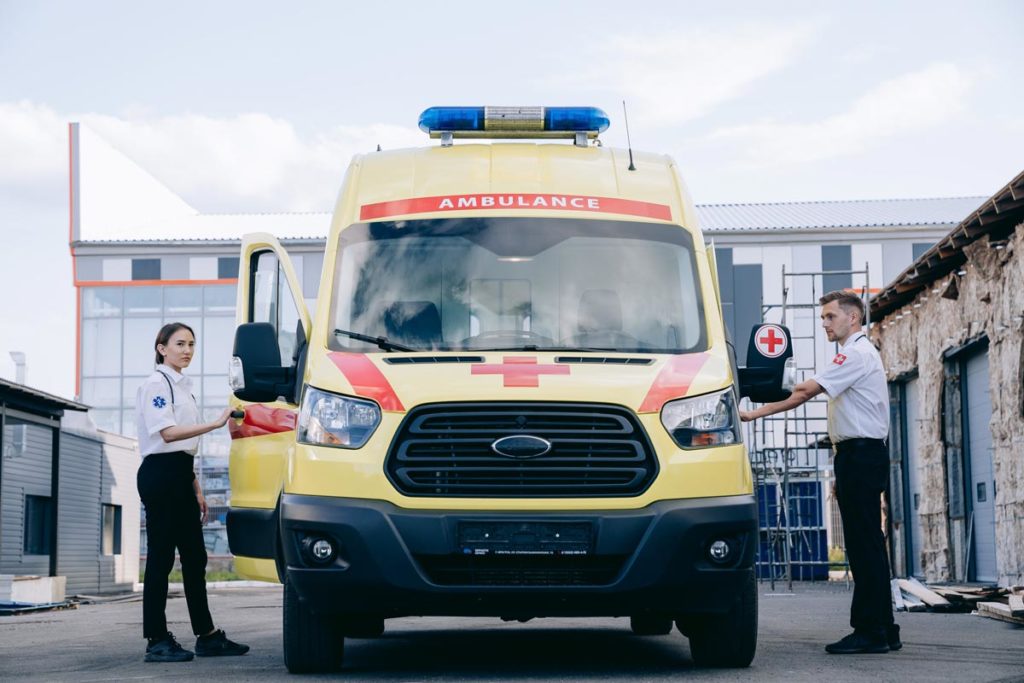 photo of a female and male first responders about to go inside an ambulance