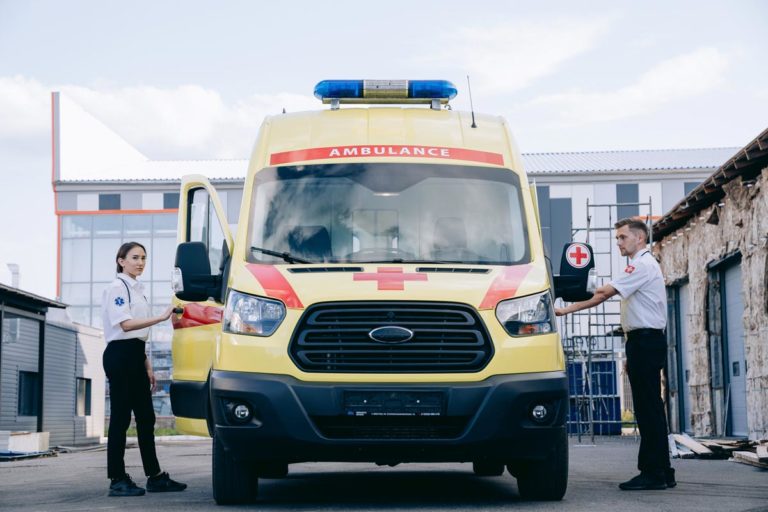 photo of a female and male first responders about to go inside an ambulance