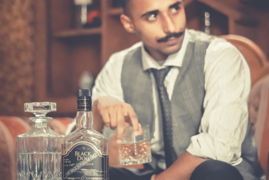 a man drinking alcohol