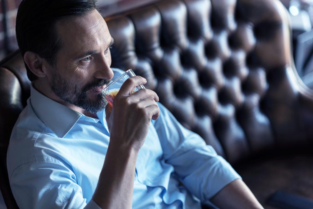 Joyful-optimistic-man-taking-a-sip