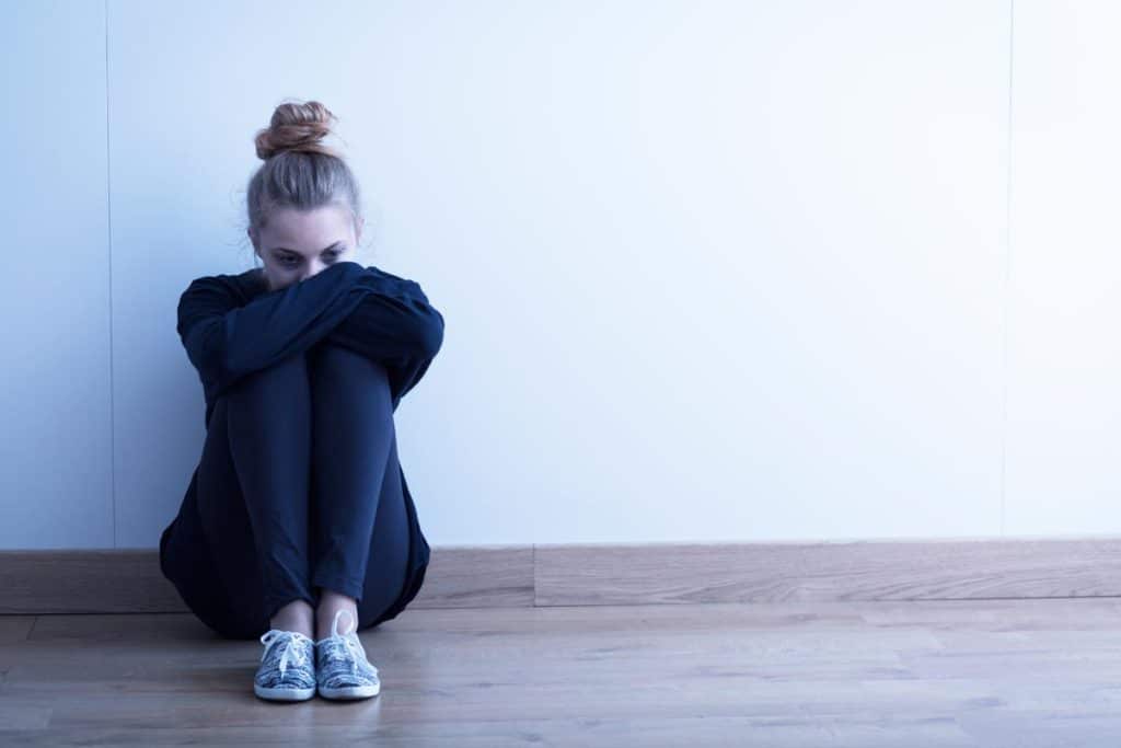 a lonely woman thinking about rehab