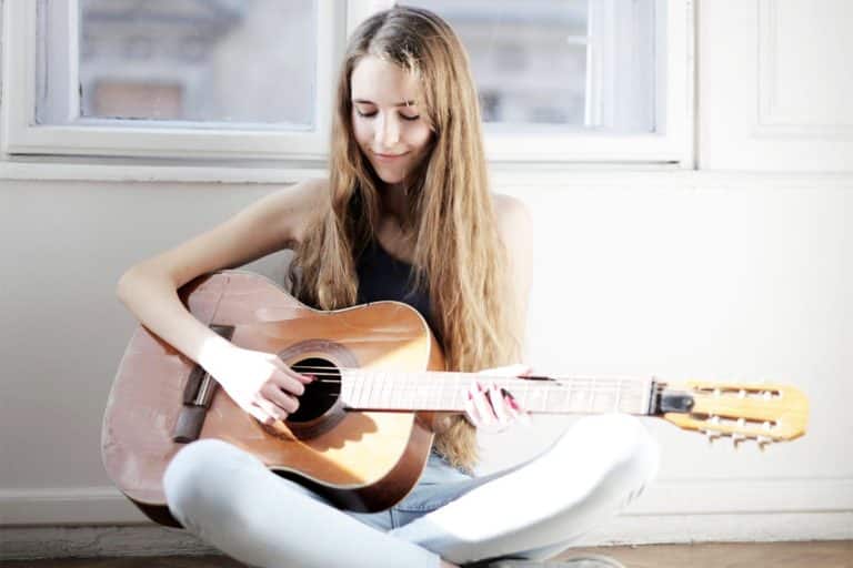 young lady playing a guitar, a new hobby