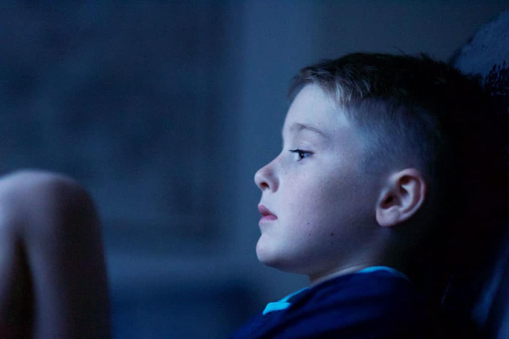 side profile of contemplative adolescent boy