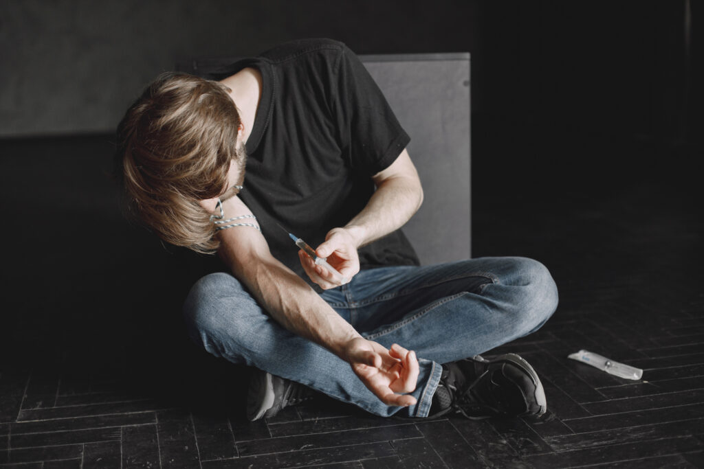 A young man injecting heroin; needs our residential program here at Asana Recovery.