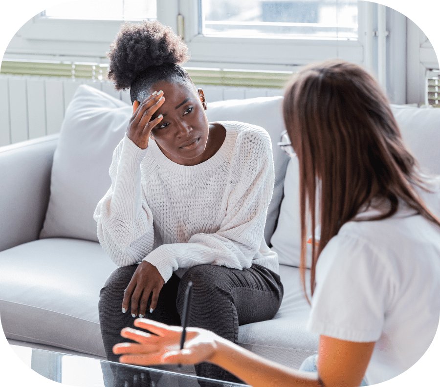 A young lady speaking with therapist about her mental health.