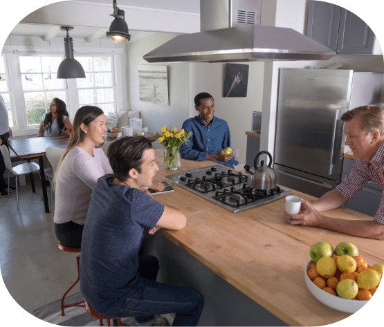 A group of patients gathered around the kitchen at one of our facilities.