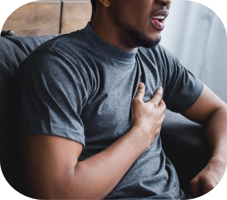 A man holding his chest, he is experiencing shortness of breath due to xanax addction.