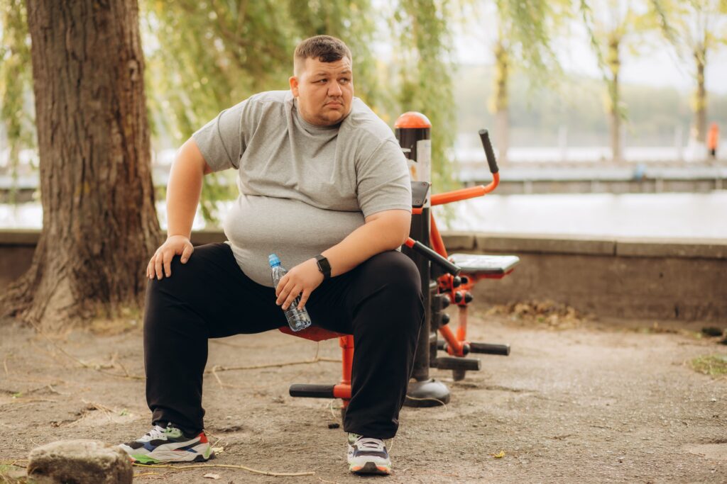 Young man working out to shed pounds post recovery.