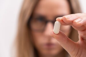 How long does it usually take for phenibut to start working?-close-up-of-female-hand-holding-white-pill-or-caps-2024-12-05-18-18-16-utc (1).jpg