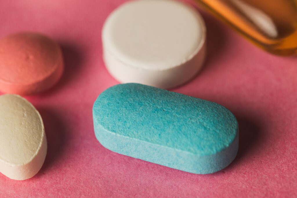 Percocet Pill Identifier Blue-closeup-of-pills-arranged-on-a-pink-surface-2023-11-27-05-04-39-utc.jpg
