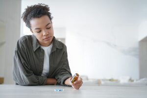 Is it difficult to stop taking phenibut once you start?-pensive-young-woman-holds-bottle-with-medicines-do-2023-11-27-05-27-44-utc (1).jpg