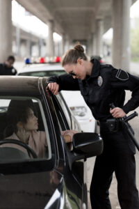 Can you refuse a field sobriety test in Costa Mesa?-side-view-of-policewoman-holding-truncheon-and-tal-2024-11-09-03-32-23-utc.jpg