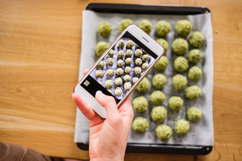 Weed on Snapchat: Understanding the Risks-woman-taking-pictures-with-food-on-phone-2024-10-19-08-43-57-utc.jpg