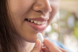 What is the difference between taking phenibut occasionally vs. frequently?-young-woman-taking-medicine-pill-after-doctor-orde-2023-11-27-04-56-29-utc (1).jpg